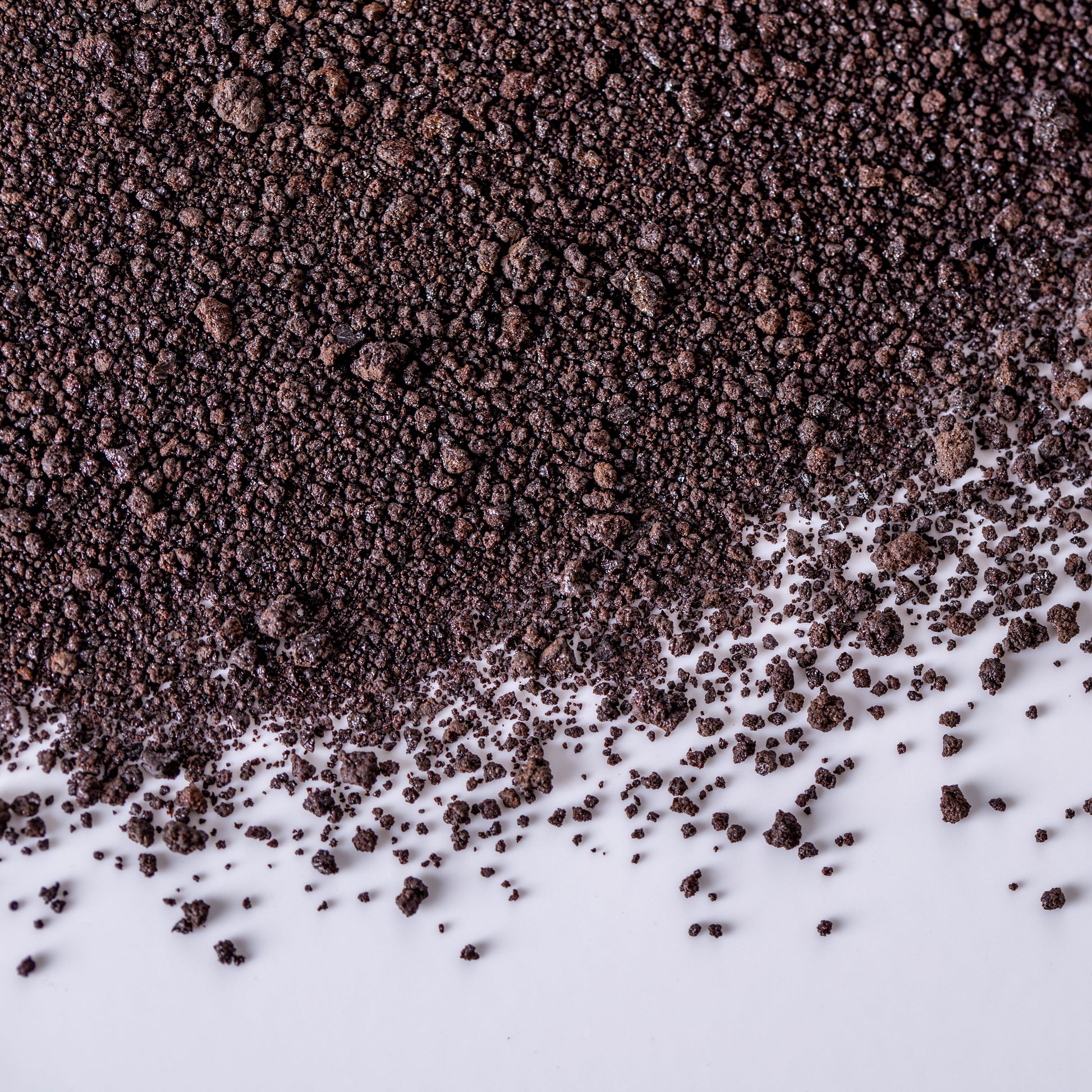 Agrobiogel dark granular hydrogel soil water retention product spread on white surface